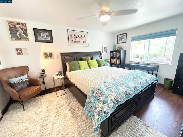 bedroom with ceiling fan and dark hardwood / wood-style flooring