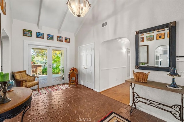 entryway with french doors, hardwood / wood-style flooring, an inviting chandelier, high vaulted ceiling, and beamed ceiling