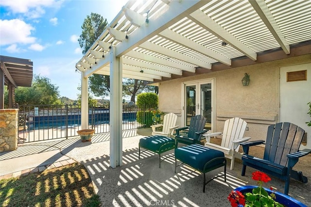 view of patio featuring a fenced in pool, a pergola, and french doors