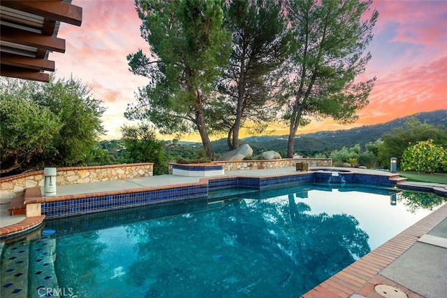 view of pool at dusk