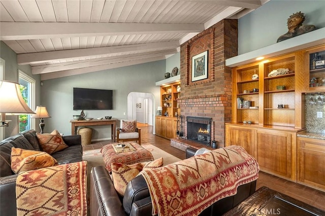 living room with wood-type flooring, vaulted ceiling with beams, a brick fireplace, and wood ceiling