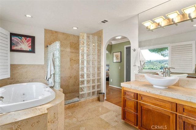 bathroom featuring vanity, plus walk in shower, and ornamental molding