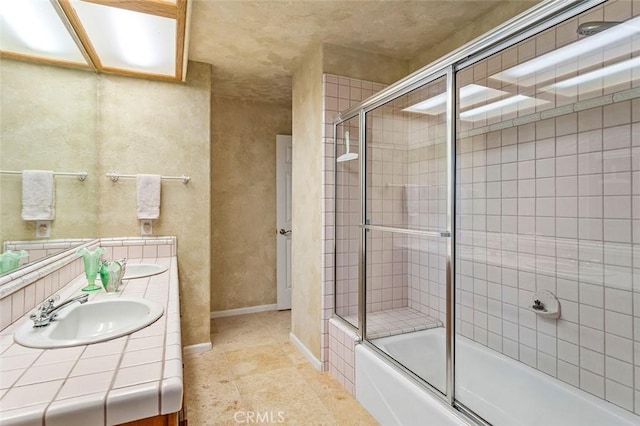 bathroom featuring vanity and combined bath / shower with glass door