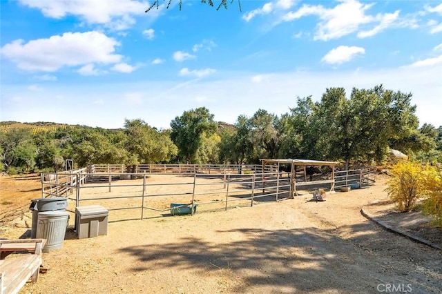 view of horse barn featuring a rural view