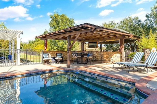 view of pool featuring a pergola, a patio, and exterior bar