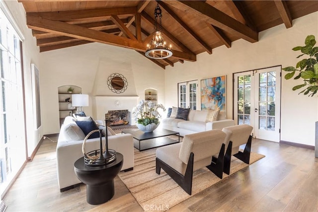 living room featuring beam ceiling, french doors, high vaulted ceiling, and light hardwood / wood-style flooring