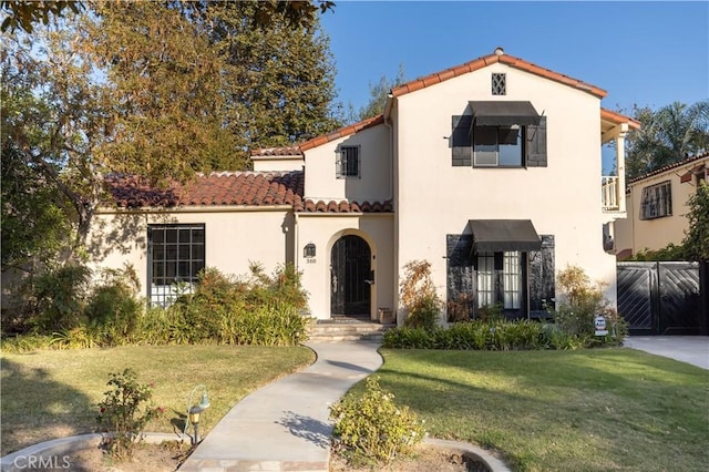 mediterranean / spanish-style house with a front lawn