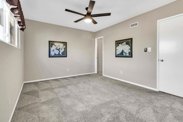 spare room featuring light carpet and ceiling fan