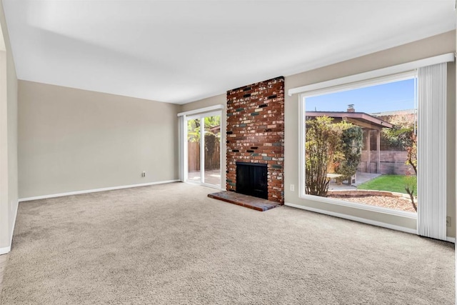 unfurnished living room with carpet and a fireplace