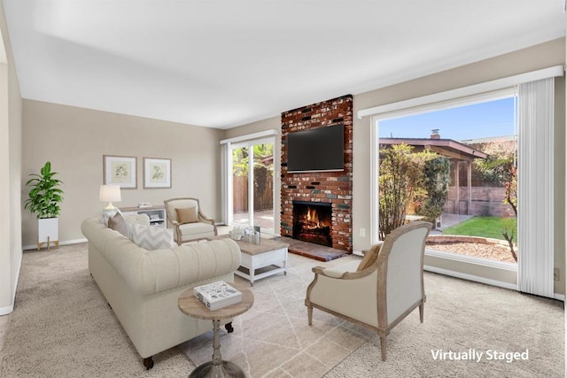 carpeted living room with a wealth of natural light and a fireplace