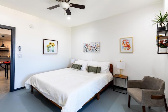 bedroom featuring ceiling fan and concrete flooring