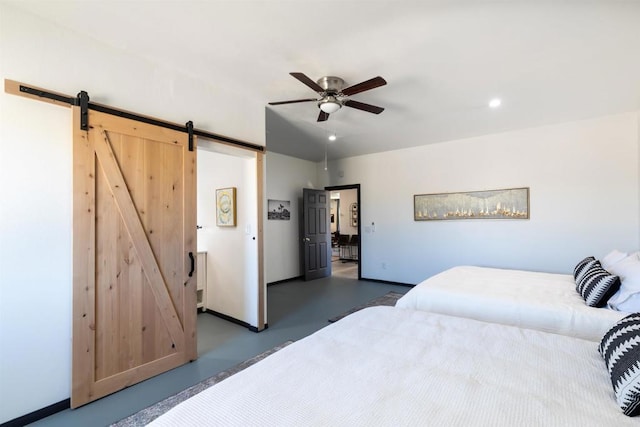 bedroom featuring a barn door and ceiling fan