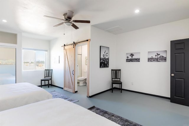 bedroom featuring connected bathroom, a barn door, and ceiling fan