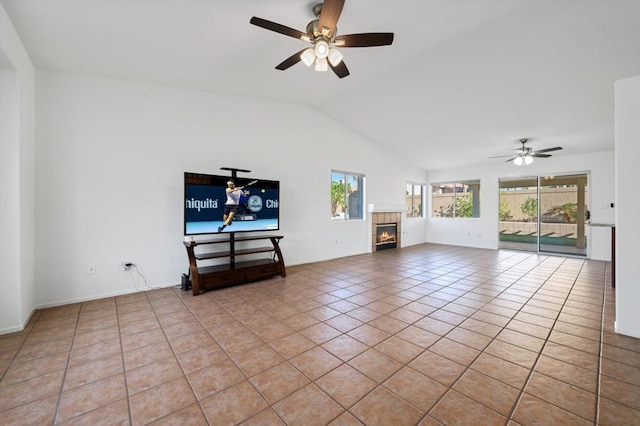 unfurnished living room featuring light tile patterned floors, vaulted ceiling, plenty of natural light, and a tiled fireplace