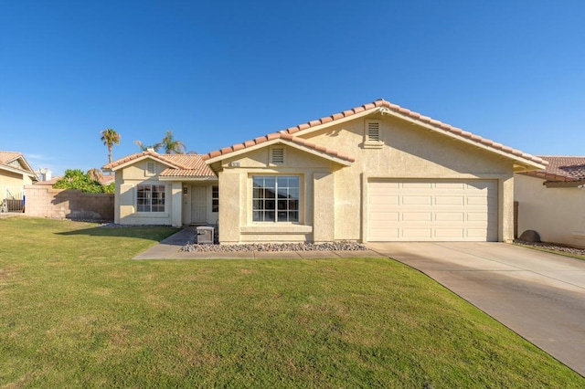 view of front of property featuring a garage and a front lawn