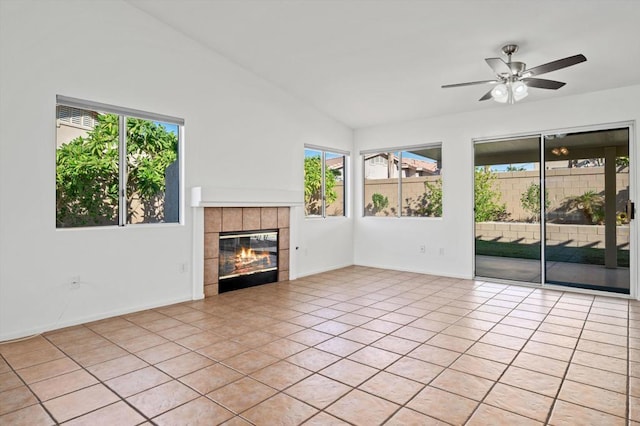 unfurnished living room featuring ceiling fan, light tile patterned floors, a fireplace, and vaulted ceiling