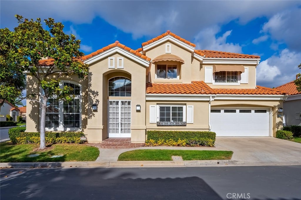 mediterranean / spanish house featuring a garage