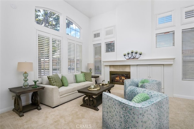 living room with light colored carpet and a tiled fireplace