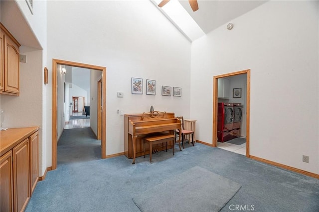 miscellaneous room featuring ceiling fan, high vaulted ceiling, light colored carpet, and independent washer and dryer