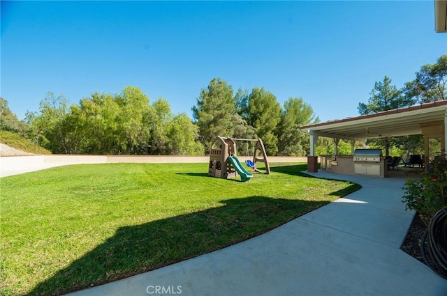 view of yard with a playground and an outdoor kitchen