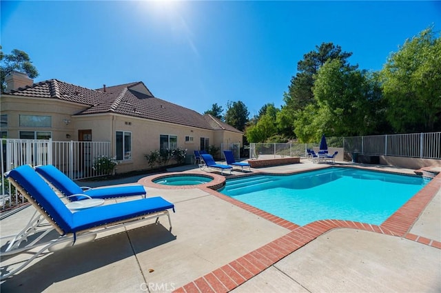 view of swimming pool with a patio area and an in ground hot tub