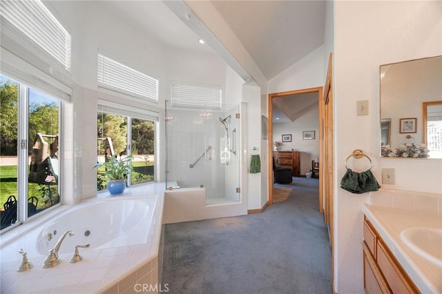 bathroom with vanity, lofted ceiling, and shower with separate bathtub