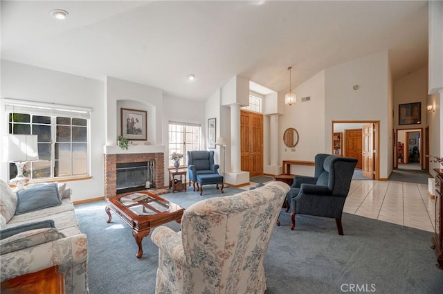 living room featuring light colored carpet, high vaulted ceiling, and a brick fireplace