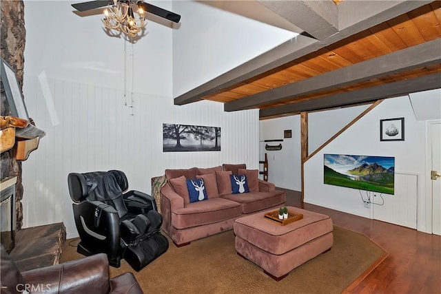 living room featuring hardwood / wood-style floors, wooden ceiling, ceiling fan, a fireplace, and beamed ceiling