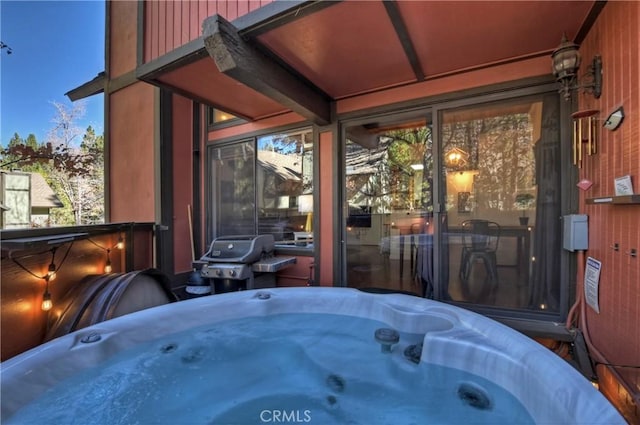 view of patio / terrace featuring area for grilling and a hot tub