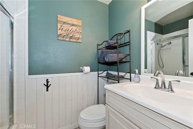 bathroom with vanity, toilet, and a shower with shower door