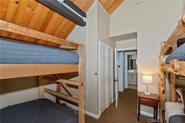 unfurnished bedroom featuring carpet flooring, beamed ceiling, wood ceiling, and high vaulted ceiling