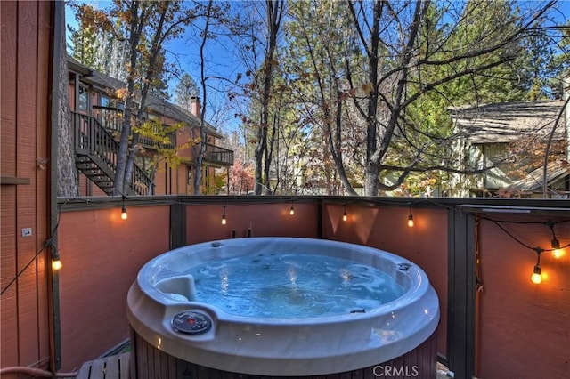 view of swimming pool with a hot tub