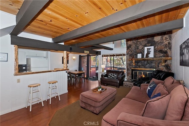 living room featuring a fireplace, beamed ceiling, wood ceiling, and dark hardwood / wood-style floors