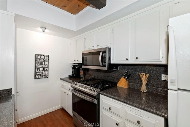 kitchen with dark hardwood / wood-style flooring, white cabinetry, and stainless steel appliances