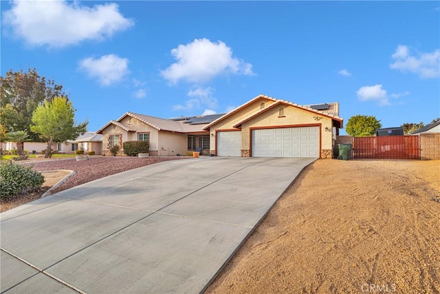 single story home with solar panels and a garage