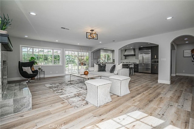 living room with a chandelier and light hardwood / wood-style floors