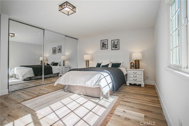 bedroom featuring a closet and light wood-type flooring