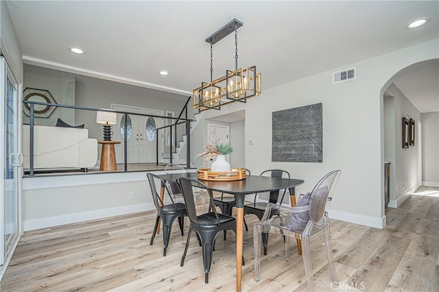 dining space featuring a chandelier and light hardwood / wood-style flooring