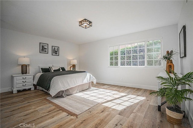 bedroom with hardwood / wood-style flooring