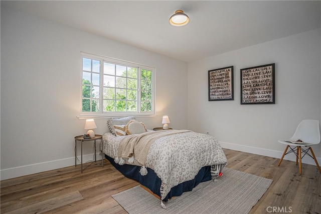 bedroom with hardwood / wood-style flooring