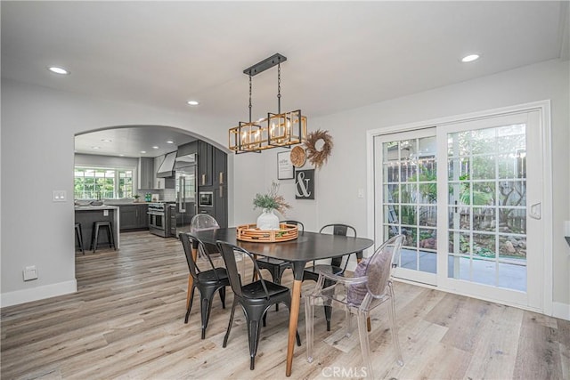 dining room featuring a chandelier and light hardwood / wood-style flooring