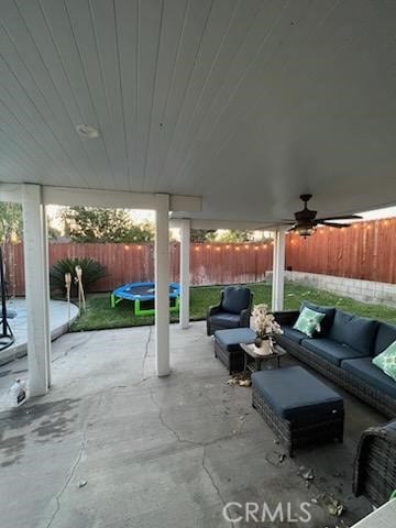 view of patio / terrace with outdoor lounge area, a trampoline, and ceiling fan