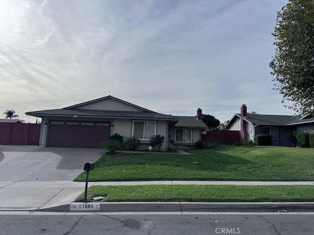 ranch-style home with a front yard and a garage