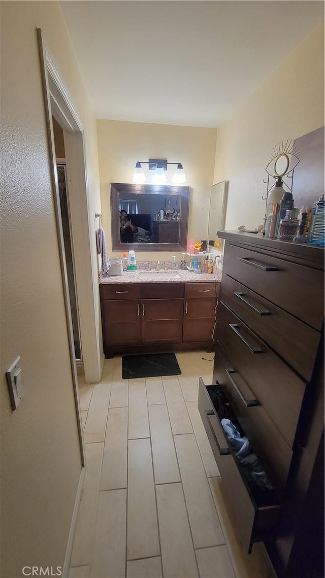 bathroom with tile patterned flooring and vanity