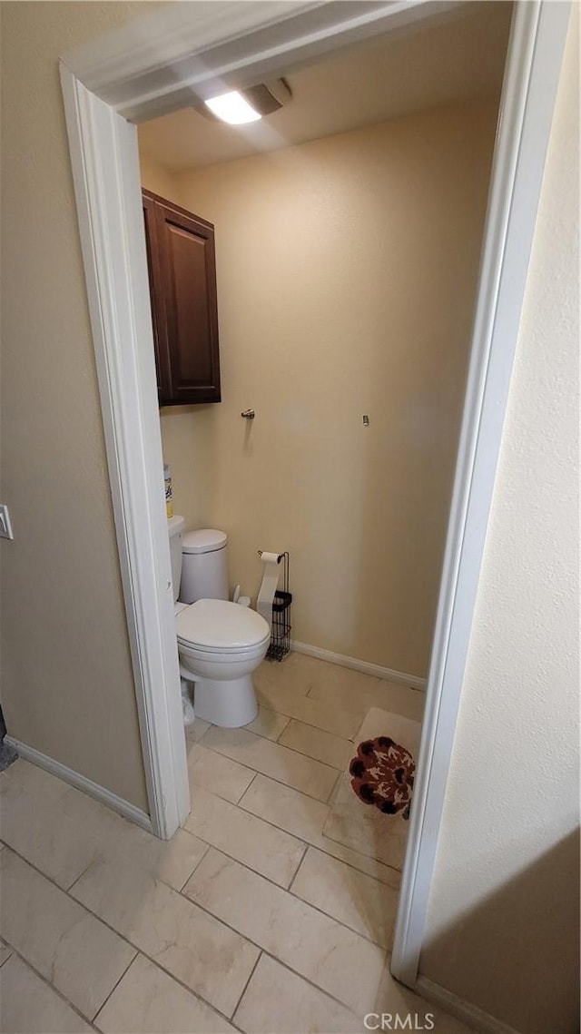 bathroom featuring tile patterned flooring and toilet