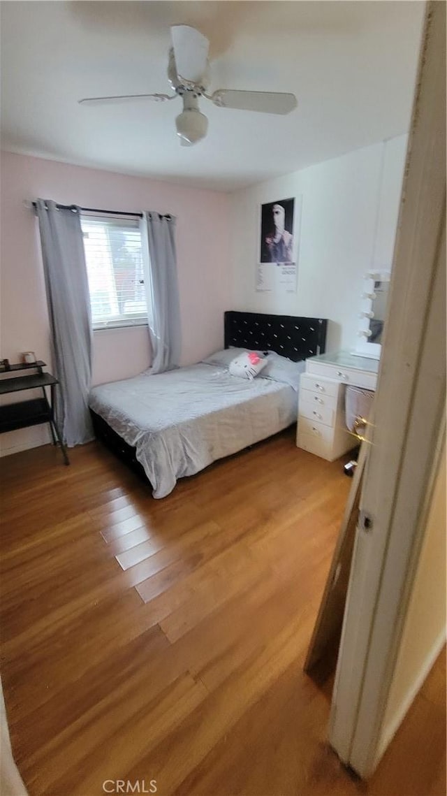 bedroom featuring ceiling fan and hardwood / wood-style floors