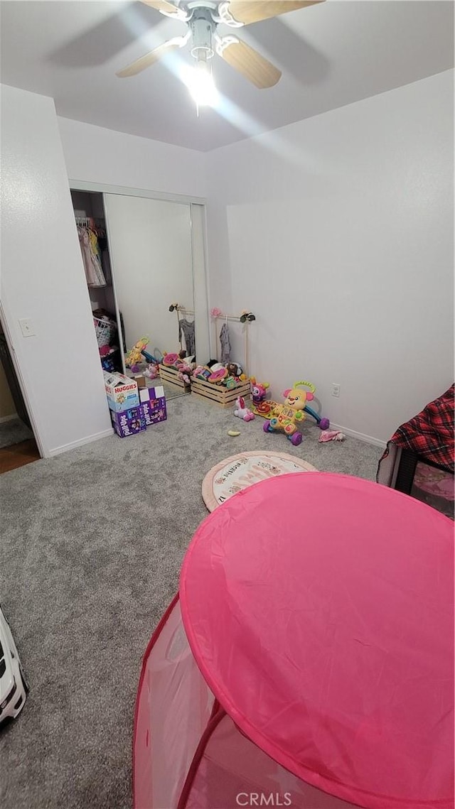 bedroom featuring carpet floors, a closet, and ceiling fan