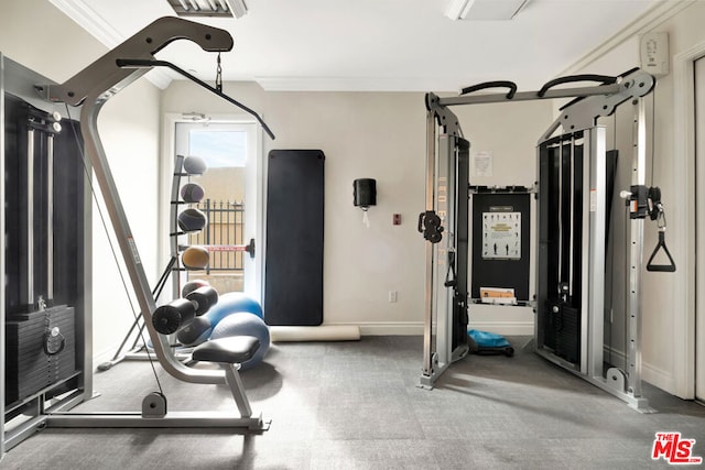 exercise area featuring crown molding