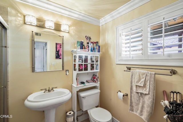 bathroom with toilet and crown molding