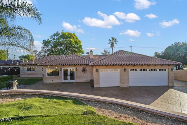 view of front of house with french doors and a garage